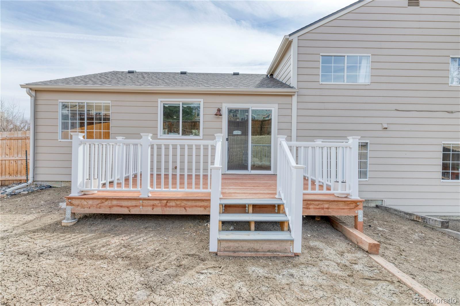 6723 East Rustic Drive Parker, CO 80138 - Photo 32 of 32 a view of a house with a backyard