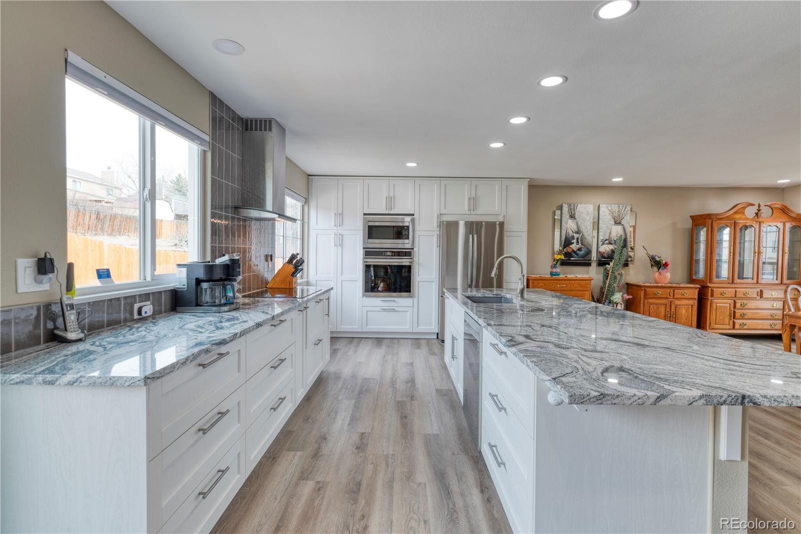 6723 East Rustic Drive Parker, CO 80138 - Photo 10 of 32 a large kitchen with granite countertop a large counter top cabinets and stainless steel appliances