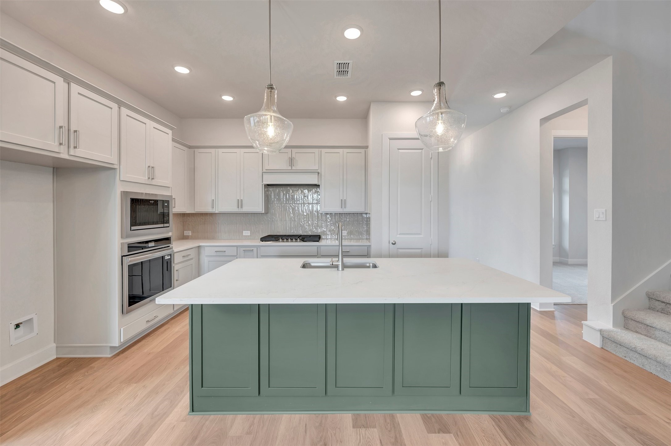 2718 Cottage Place Rosharon, TX 77583 - Photo 21 of 50 a large kitchen with kitchen island a sink stainless steel appliances and cabinets
