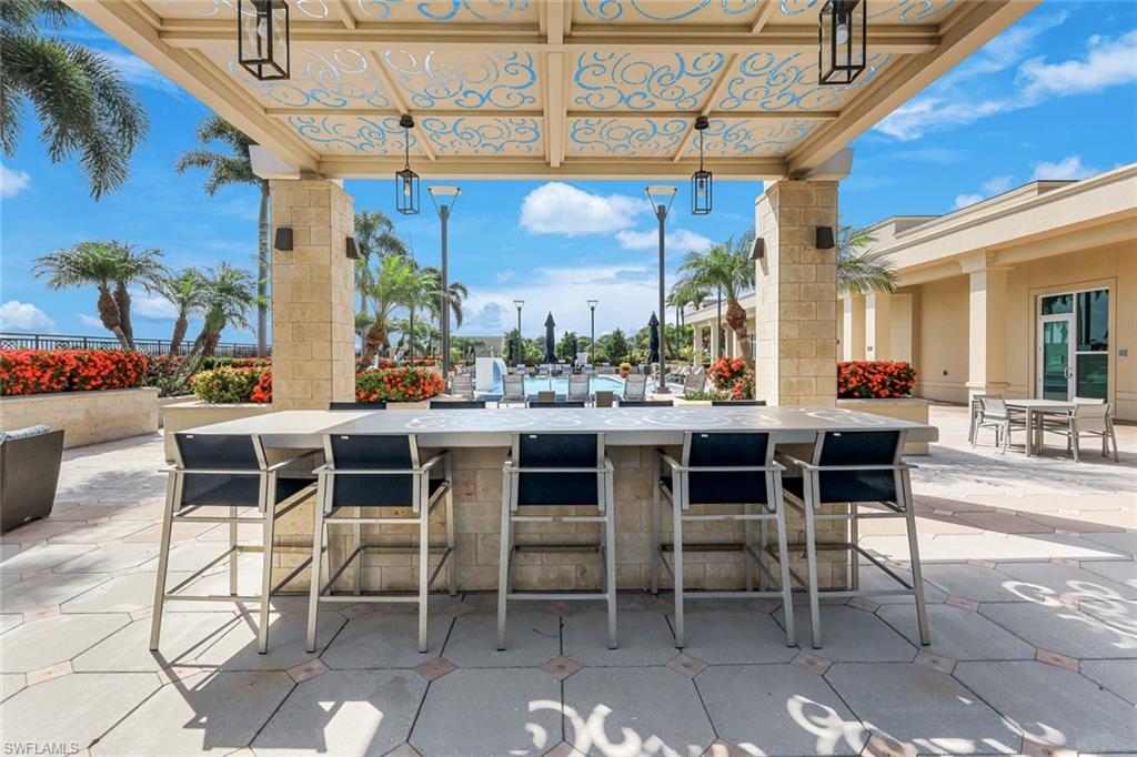 9123 Strada Place, Unit 7201 Naples, FL 34108 - Photo 30 of 50 a dining area with a table and chairs