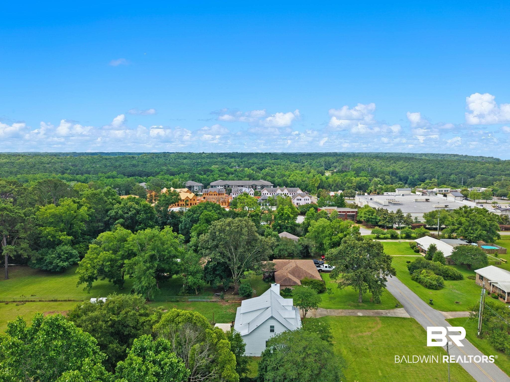 22810 High Ridge Road Fairhope, AL 36532 - Photo 72 of 78 Aerial perspective showcasing a white-sided home with a gabled roof, surrounded by green lawns and mature trees