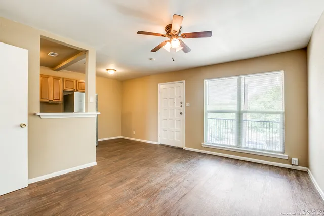 wooden floor in an empty room with a window