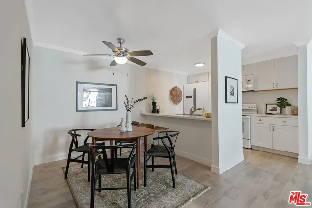 a view of a dining room with furniture and a chandelier fan