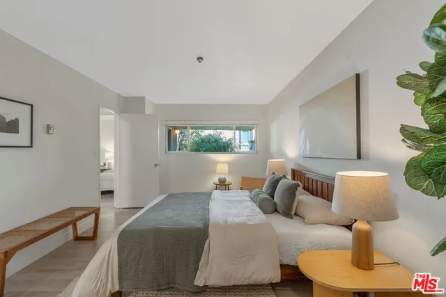 a bedroom with furniture and a window