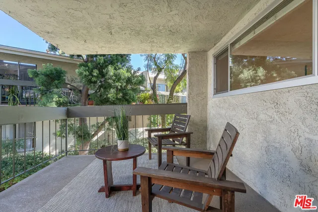 a view of a porch with furniture and garden