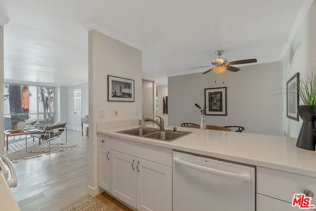 a hallway with sink and mirror
