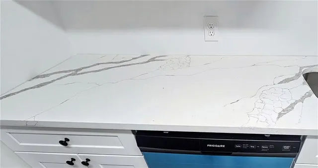 an empty room with a window and a ceiling fan