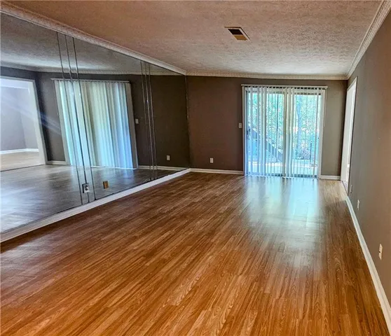 a view of a room with wooden floor and window