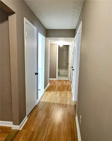 a view of a hallway with wooden floor
