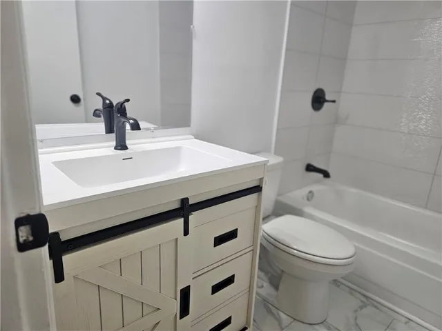 a bathroom with a sink a toilet and a bathtub