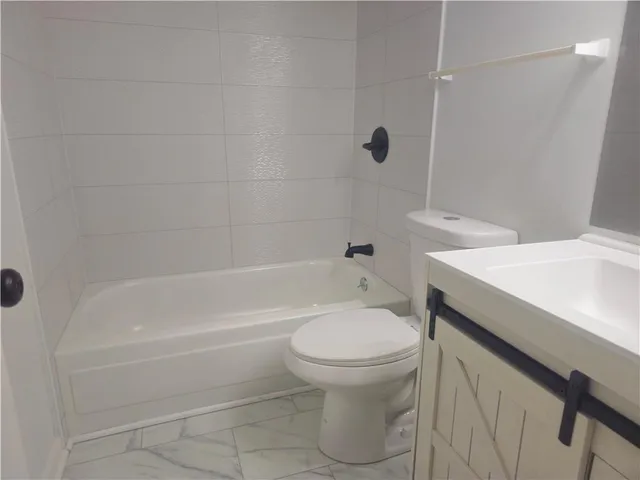 a utility room with cabinets washer and dryer