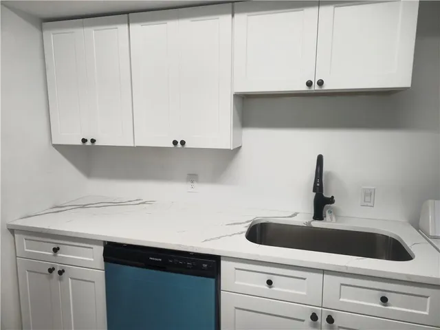 a view of a kitchen with sink and washer