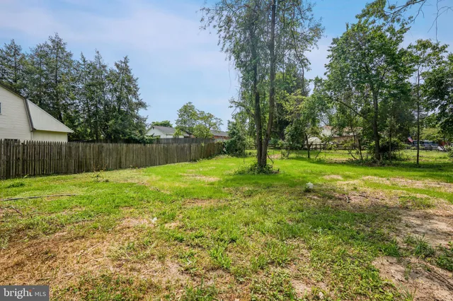 an empty room with wooden floor & closet and windows