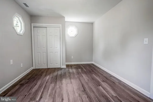 a view of a hallway view with wooden floor and staircase