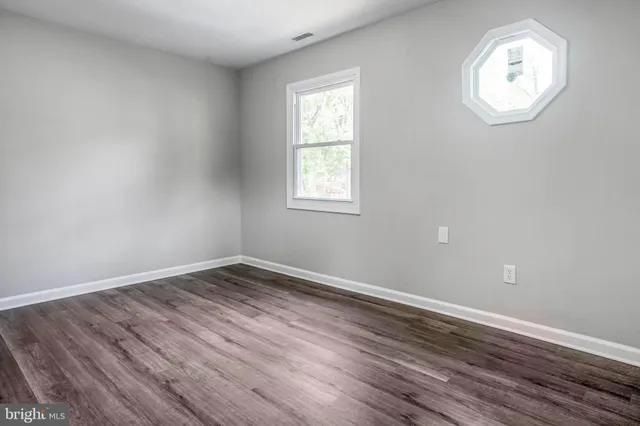 a view of wooden floor and closet in a room