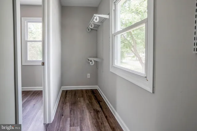 a view of an empty room with wooden floor