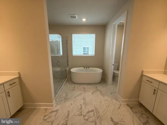 a spacious bathroom with a sink toilet and shower