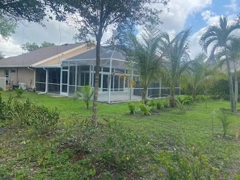 a view of a house with a yard and sitting area
