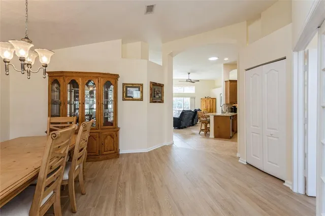 a view of a kitchen with furniture and wooden floor
