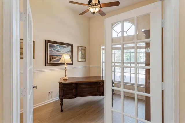 a room with chandelier and windows