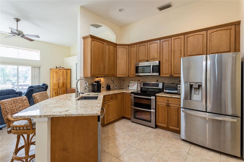 8121 Southwest Yachtsmans Drive Stuart, FL 34997 - Photo 9 of 30 KITCHEN IS CENTRALLY LOCATED IN THE HOUSE