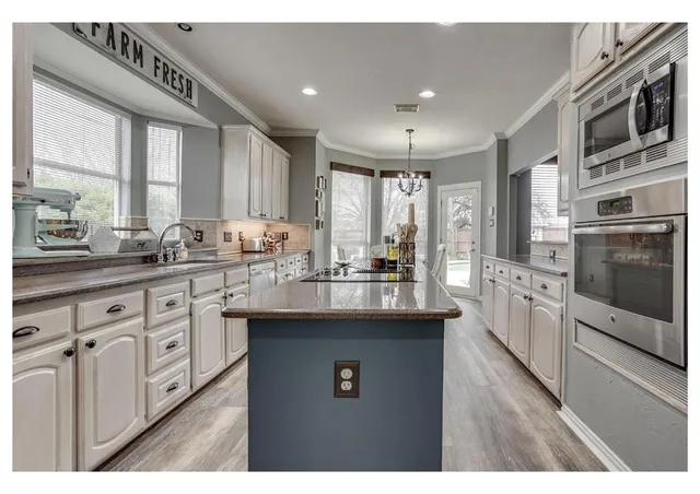a kitchen with stainless steel appliances granite countertop a sink stove and oven