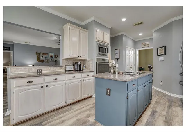 a kitchen with stainless steel appliances granite countertop a sink and cabinets
