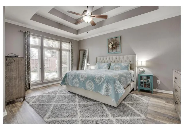 a bedroom with a large bed and a chandelier