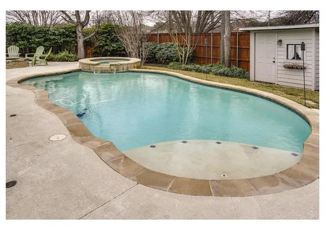 a view of a swimming pool with a yard