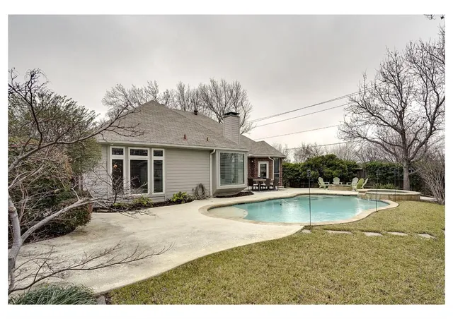 a view of a house with pool and sitting area