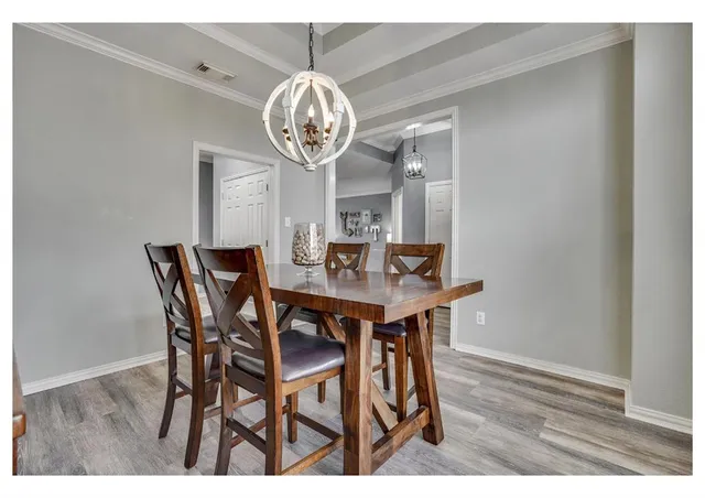 a view of a dining room with a table and chairs