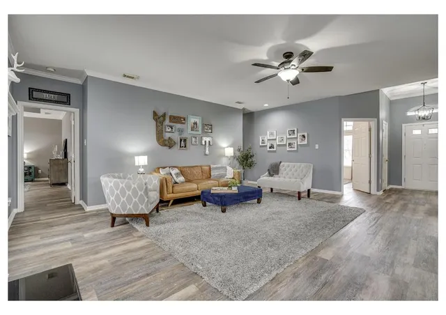 a living room with furniture and a chandelier
