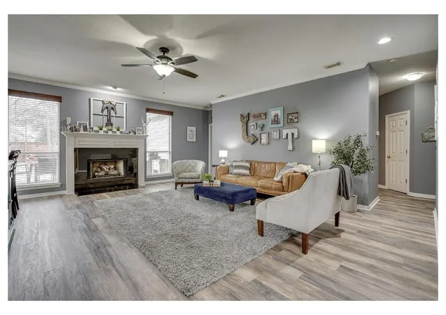 a living room with furniture and a fireplace
