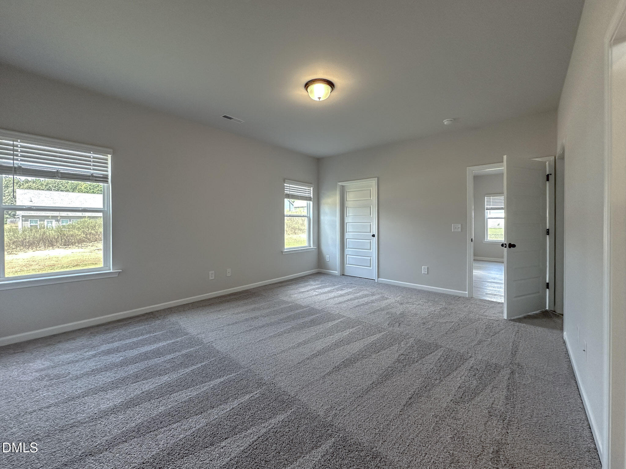 337 White Azalea Way Benson, NC 27504 - Photo 19 of 35 a view of an empty room and window