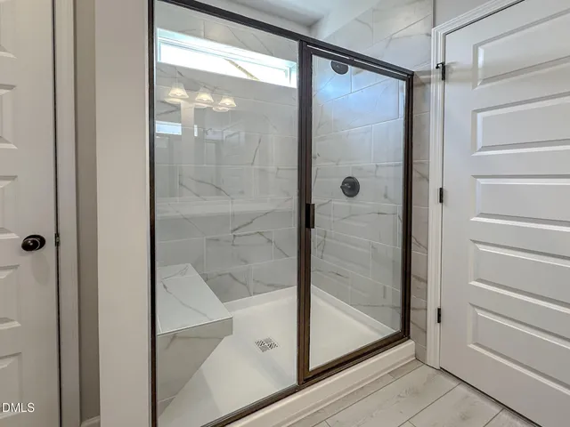 a bathroom with a glass shower door