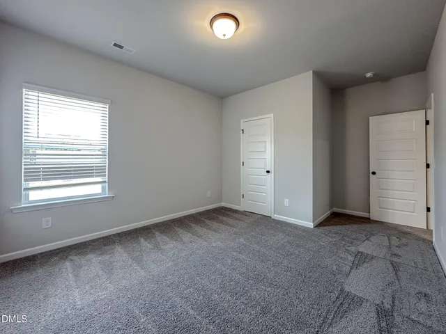 a bathroom with a sink a toilet a mirror and shower