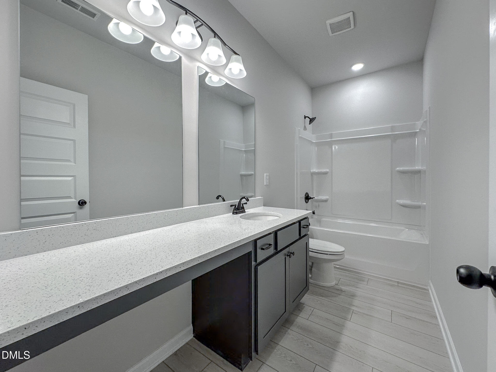 337 White Azalea Way Benson, NC 27504 - Photo 33 of 35 a bathroom with a sink a toilet a mirror and shower