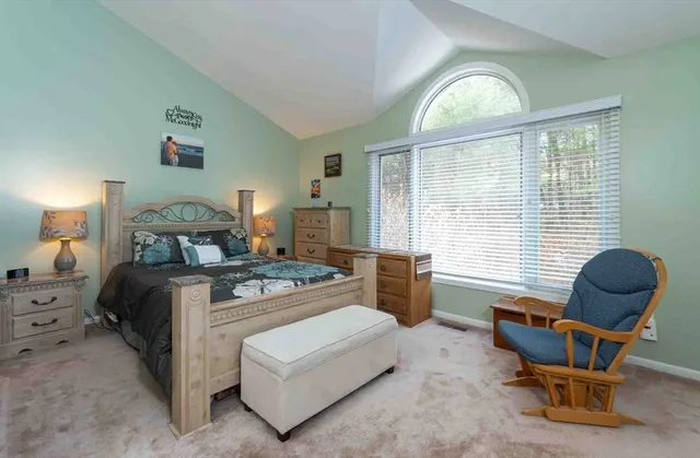 a bedroom with a bed and a chair