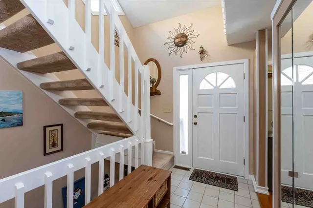 a view of staircase with railing and frames on wall