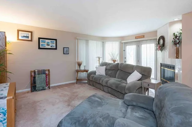 a living room with furniture a window and a flat screen tv