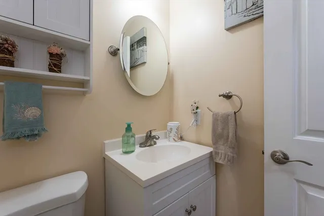 a bathroom with a sink toilet and a mirror