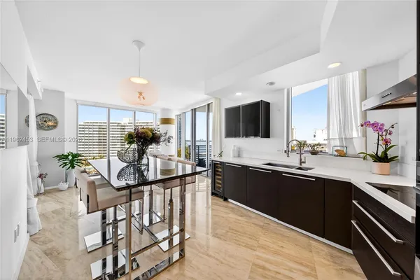 a kitchen with stainless steel appliances kitchen island granite countertop a sink and cabinets