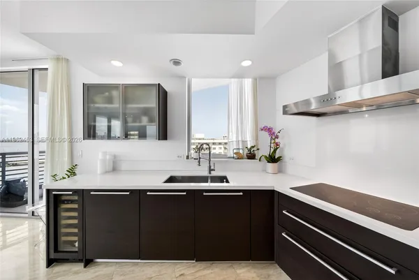 a kitchen with granite countertop a sink and cabinets