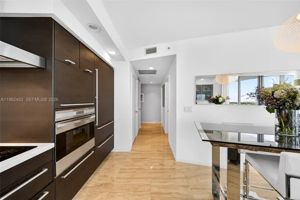 a kitchen with granite countertop stainless steel appliances and wooden cabinets
