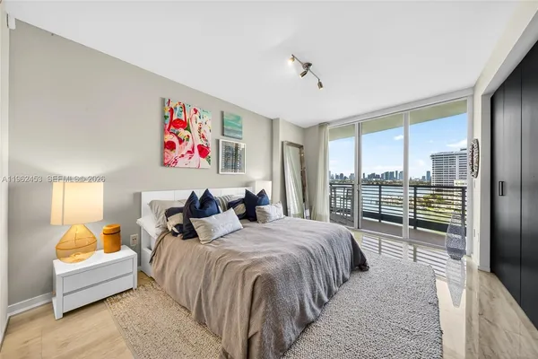 a spacious bedroom with a bed and a large window