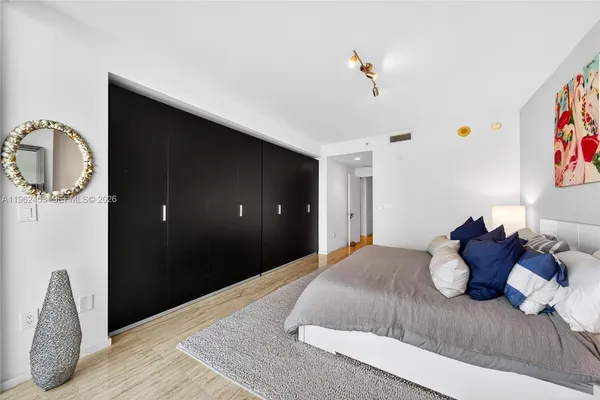 a bedroom with a bed and a chandelier