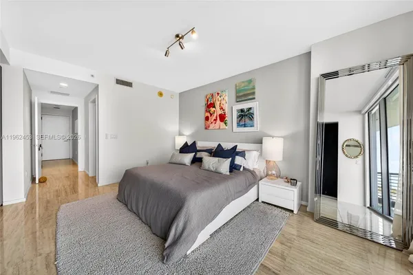 a bedroom with a bed and a chandelier