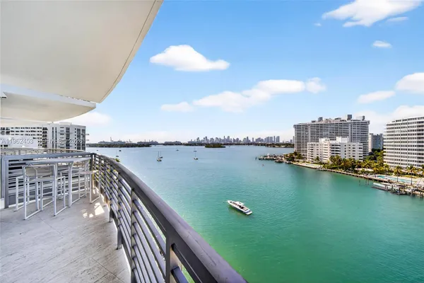 a view of swimming pool with outdoor seating and city view
