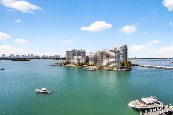 a front view of a building with lake view and tall buildings