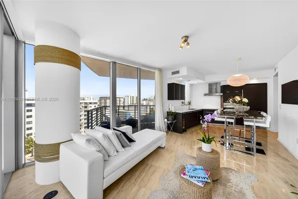 a living room with furniture fireplace and large window